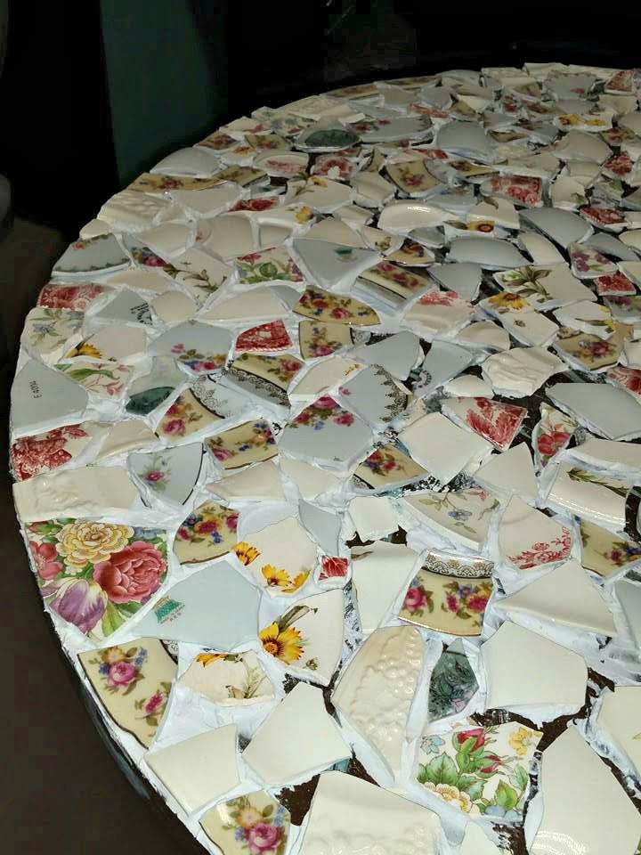 I strategically placed the broken pieces of the china on the table to fit like a well planned out puzzle. The mosaic table is coming together nicely. 