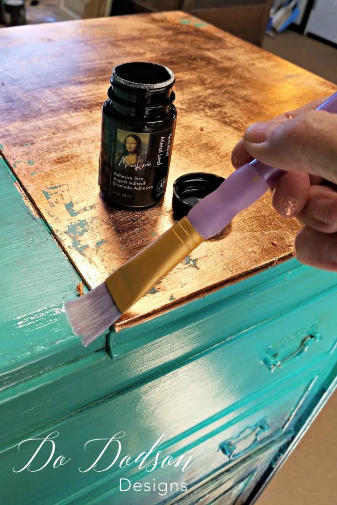 I applied the glue to the areas I wanted the gold leaf to adhere to on my painted furniture.