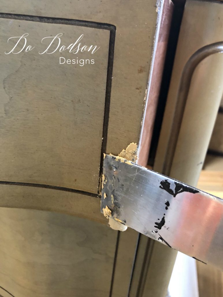 I apply to wood filler with a putty knife to the area with the missing veneer. #dododsondesigns #woodfiller #furniturerepair