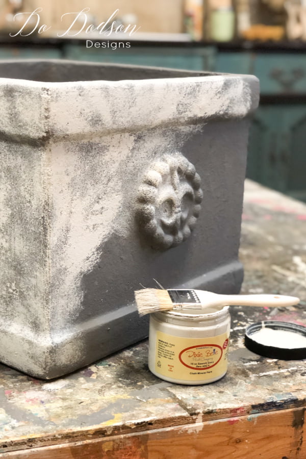 After the base coat of chalk paint is dried I added a second color to create a concrete look on my terracotta pots. I used a technique called stippling with my chip brush. Apply a small amount on the tip of the bristles of the brush and dab it on with an up and down motion instead of the back and forth. You don't want full coverage on this step. 