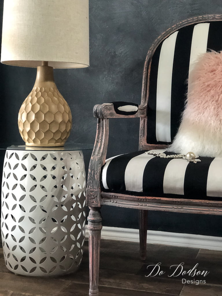 I love how the bold black and white stripes complement the aged finish on this chair makeover