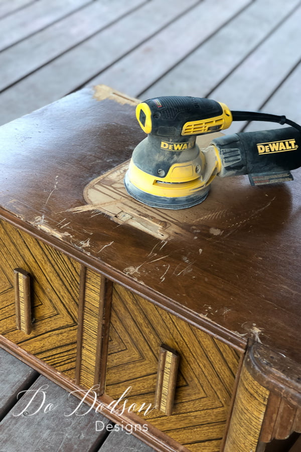 I used a rotary sander to smooth out the rough areas of the damaged wood before applying the easy wood filler. 