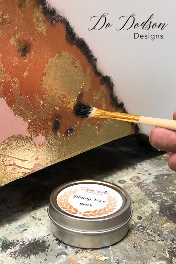 Black gilding wax added to copper and gold leaf.