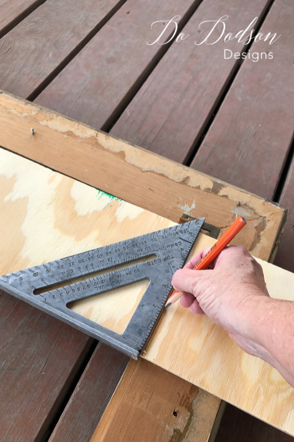 Measure the plywood to fit inside your upcyled picture frames. 