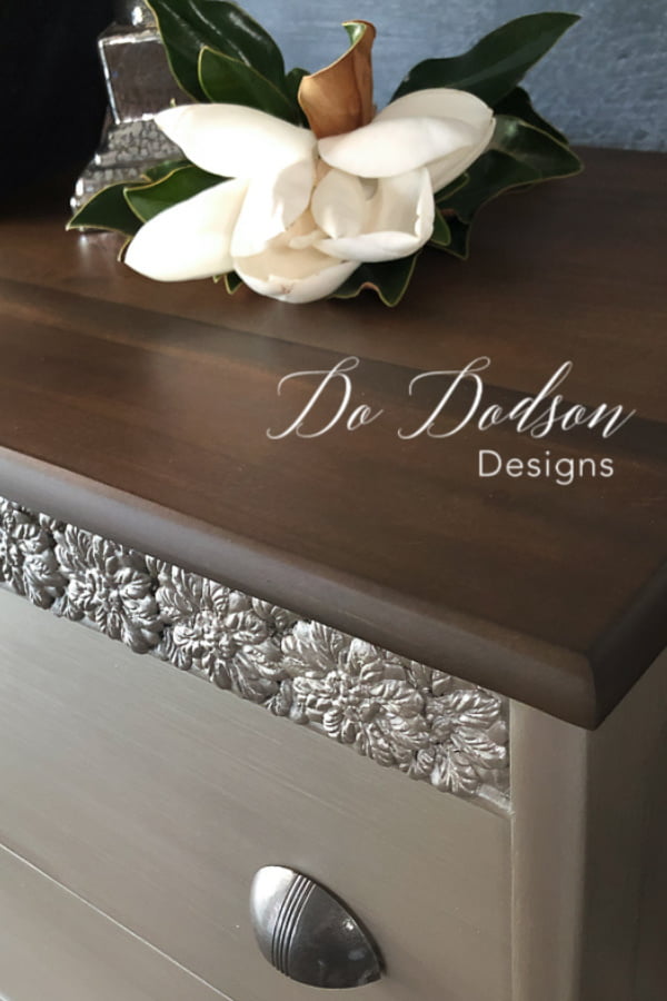 This wood top was refinished with a Gel Stain in Walnut that compliments the beautiful metallic finish on this chest.