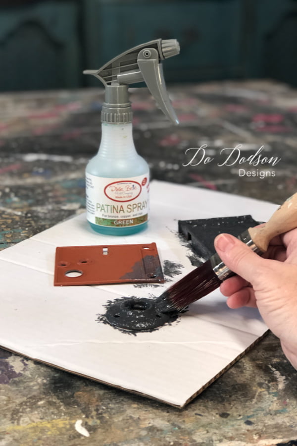 Next, paint over the metal hardware with two coats of Iron Patina paint. While the paint is still wet, spray over the Iron Paint with Green Patina Spray.