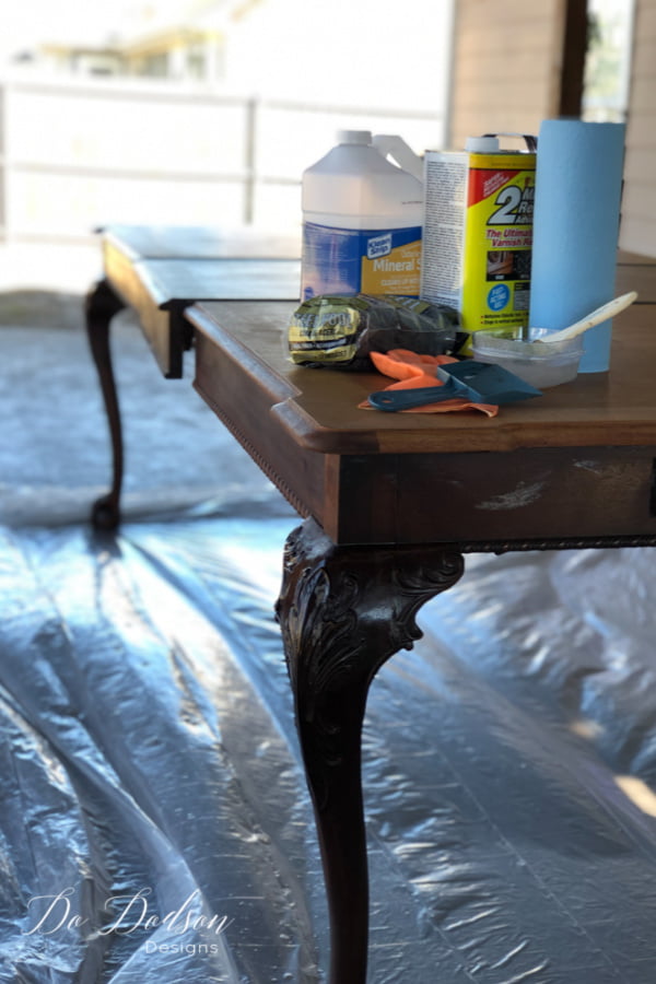 Before whitewashing a wood table, you'll need a chemical stripper to reveal the beautiful raw wood of the table top.