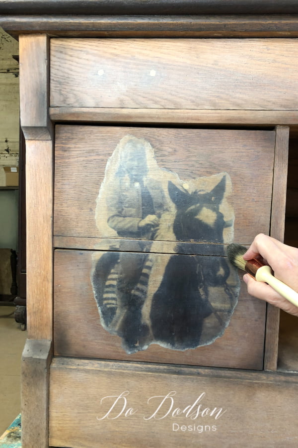 Once the topcoat is dried, try adding accents of wax over the transfer. For this project, I used white and black wax. It's a great way to add depth and a ton of character to your wood project pieces and photo transfers.