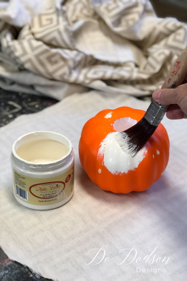 Paint the Dollar Tree pumpkin so that the orange won't show through the fabric once it's wrapped around it. 
