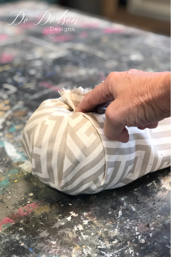 To make fabric pumpkins, start with one corner of the fabric and insert it into the hole and repeat all the way around.