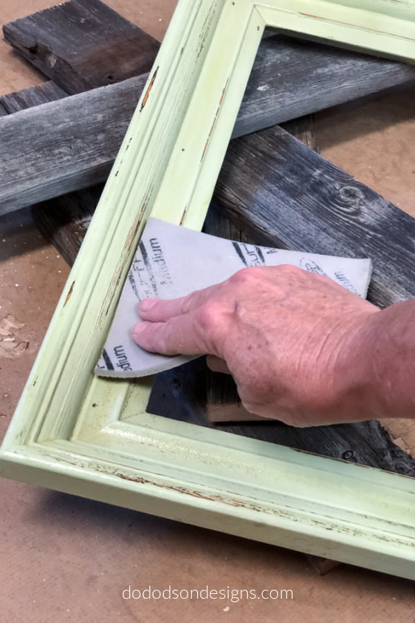 Remove and rough spots by sanding the picture frame before re-painting. 