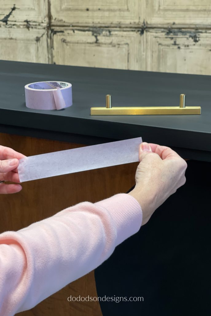 How To Replace Dresser Hardware... First, measure the length of your hardware (cabinet/dresser pulls) and cut a piece of painter's tape the same length as the hardware. This will be your guide for the perfect placement. 