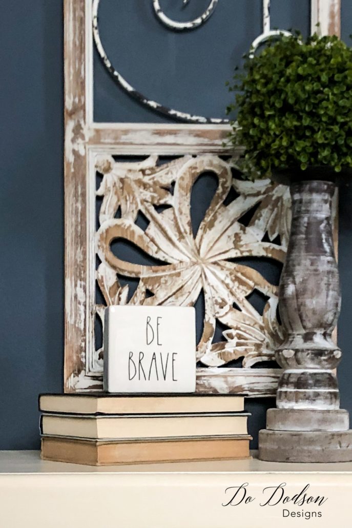 Display your favorite sign or quote on a stack of books for a stylish design element. I like the playfulness and the reminder to be brave, take risks, and allow the unexpected in home decorating. I have a lot of that! It keeps things interesting when decorating with books. 