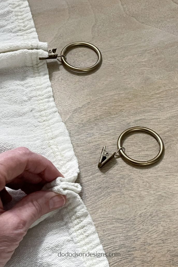 Try adding these simple pleats using curtain ring clips to hang your DIY drop cloth curtains. 