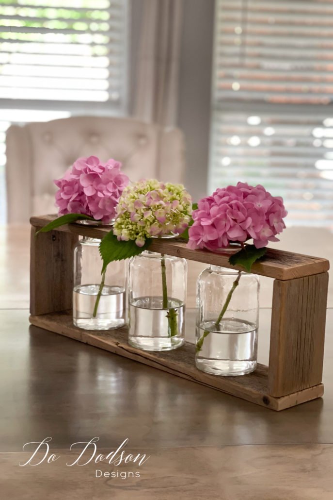 This DIY wood vase holder looks beautiful on my dining room table. I was literally running around placing them all over my home. It's the little DIY things that make me happy. Learn how I did it on the blog.