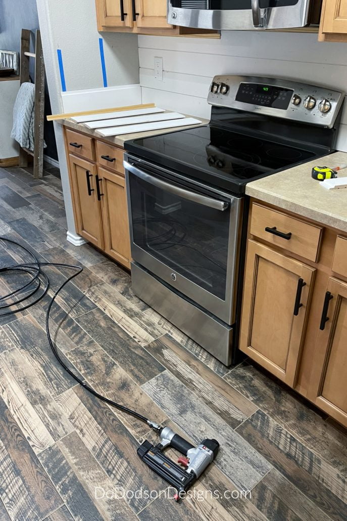 A pin nailer makes the installation of shiplap on a backsplash quick and easy. 